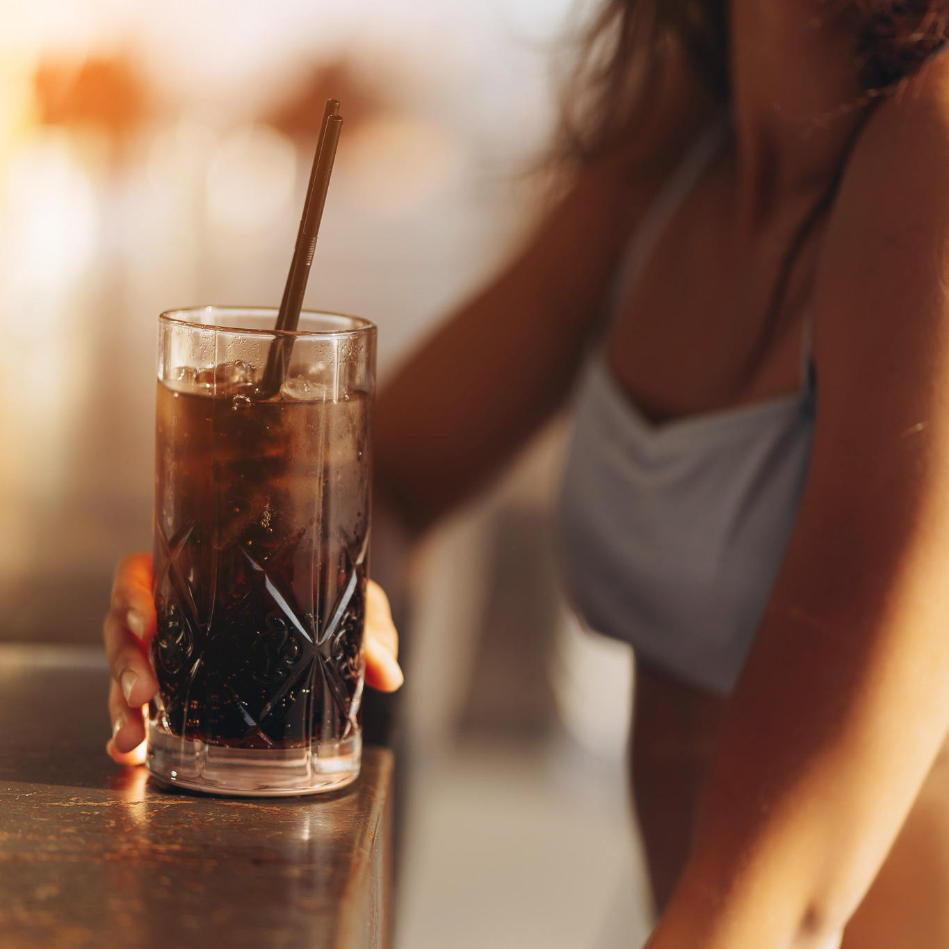 jeune femme qui boit un cocktail au café froid rafraîchissant
